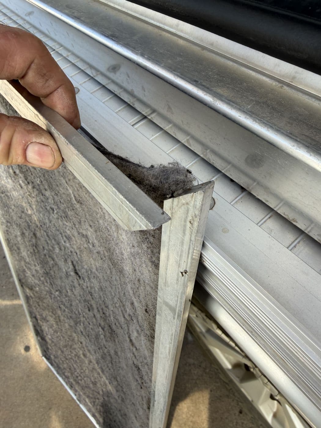 Checking a dirty ducted air conditioning filter by hand
