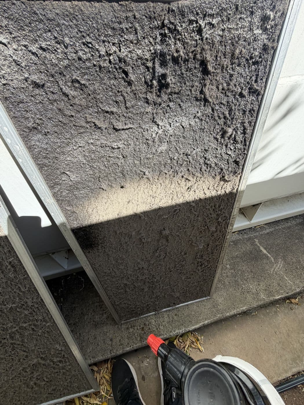 A heavily clogged ducted air conditioning filter before cleaning