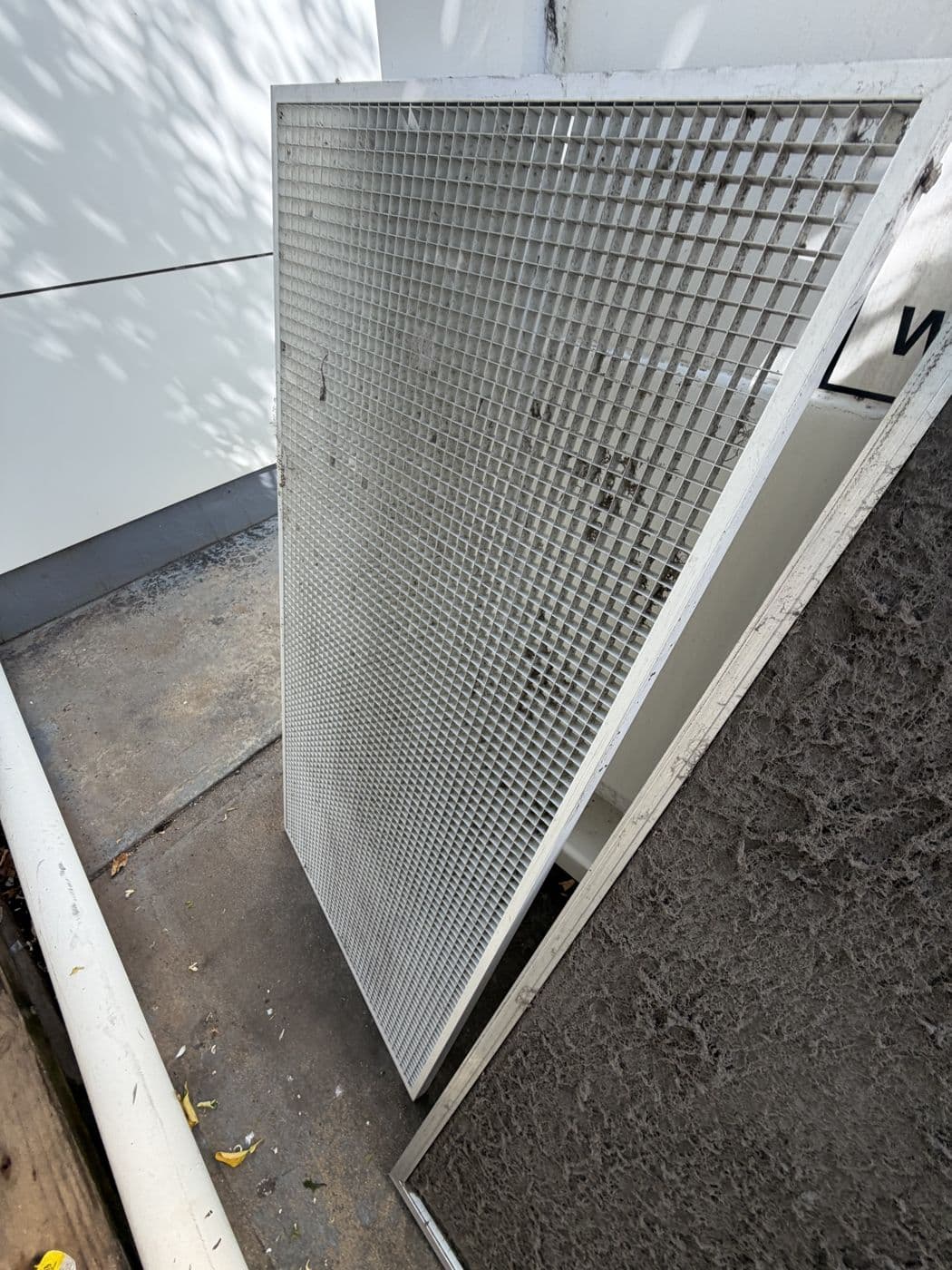 A ducted return air grille removed for cleaning