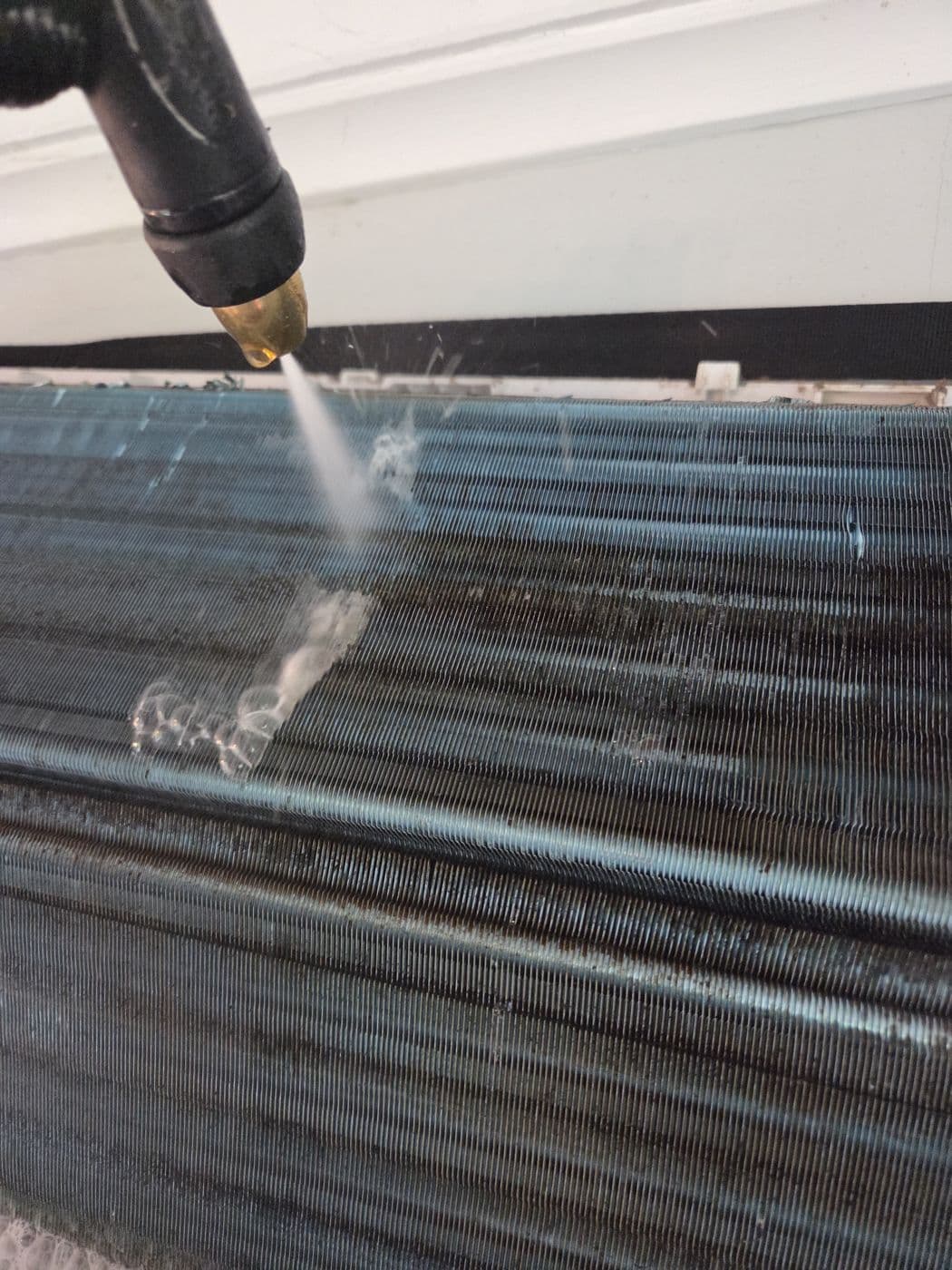 Jon cleaning a split system indoor coil on site
