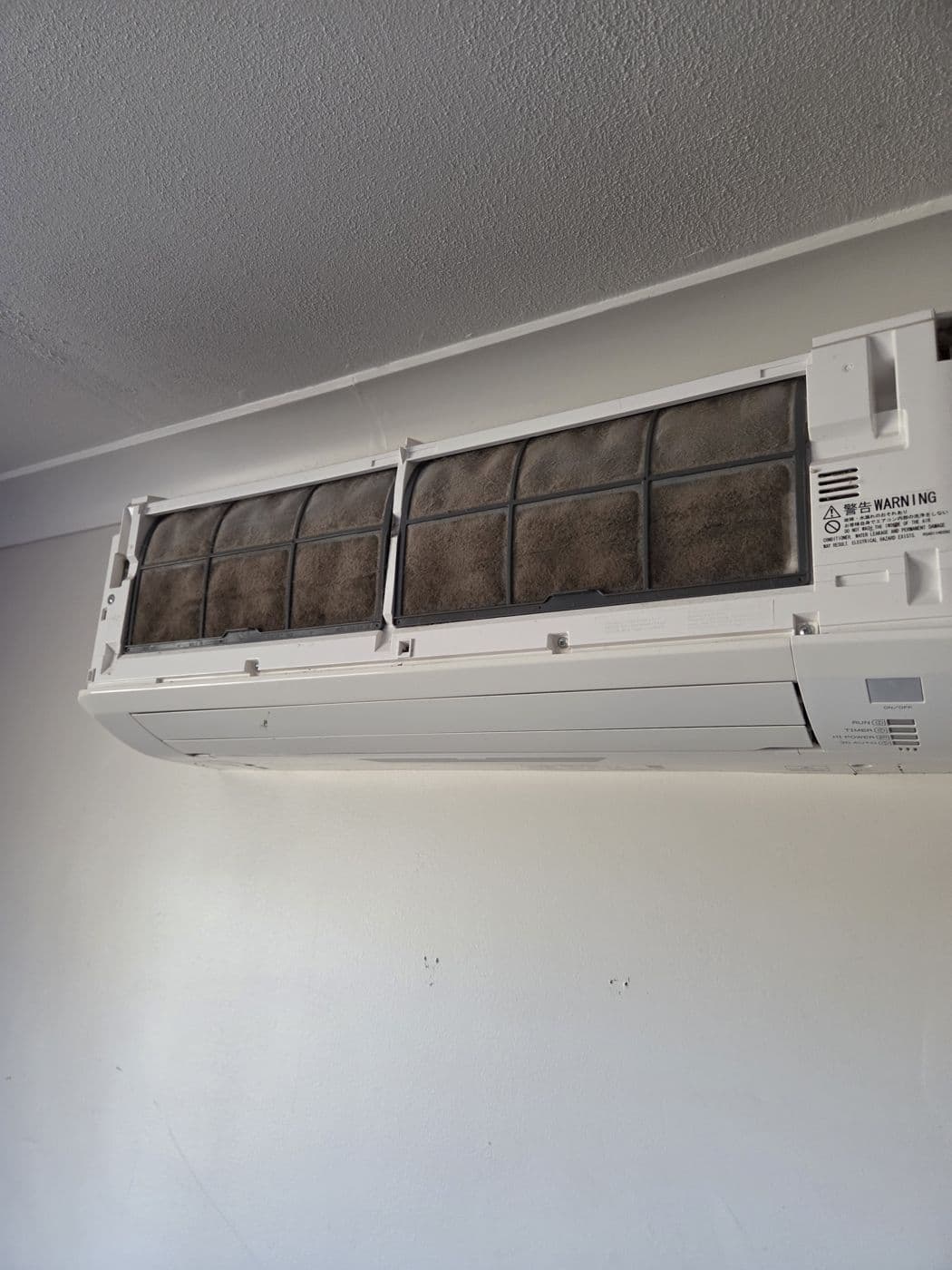 Split system filter panel removed for cleaning