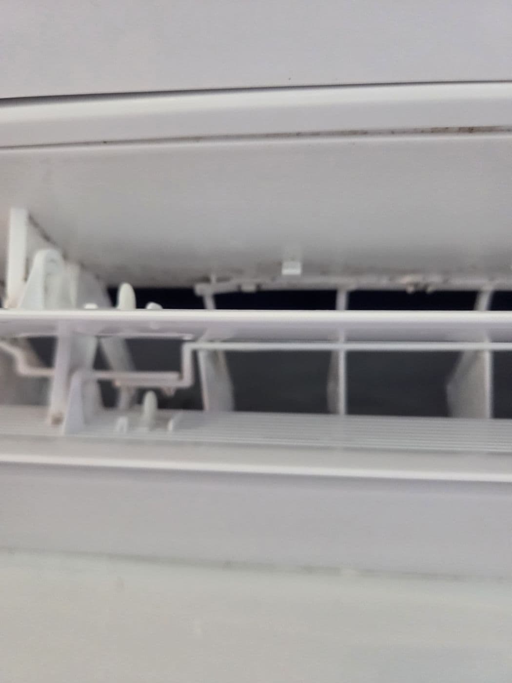 Split system indoor unit filter being cleaned