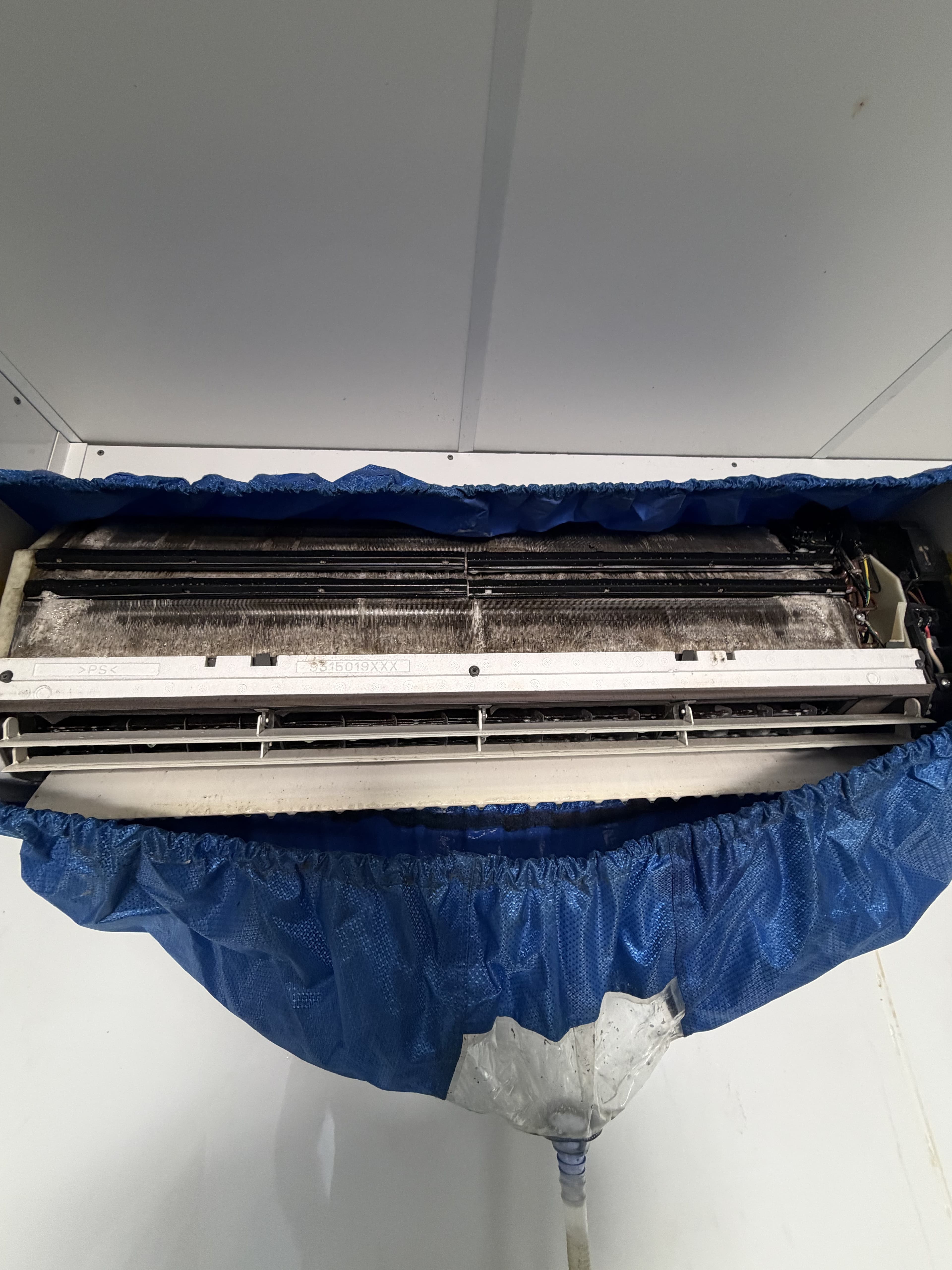 Grimy indoor coil exposed mid deep clean, before washing