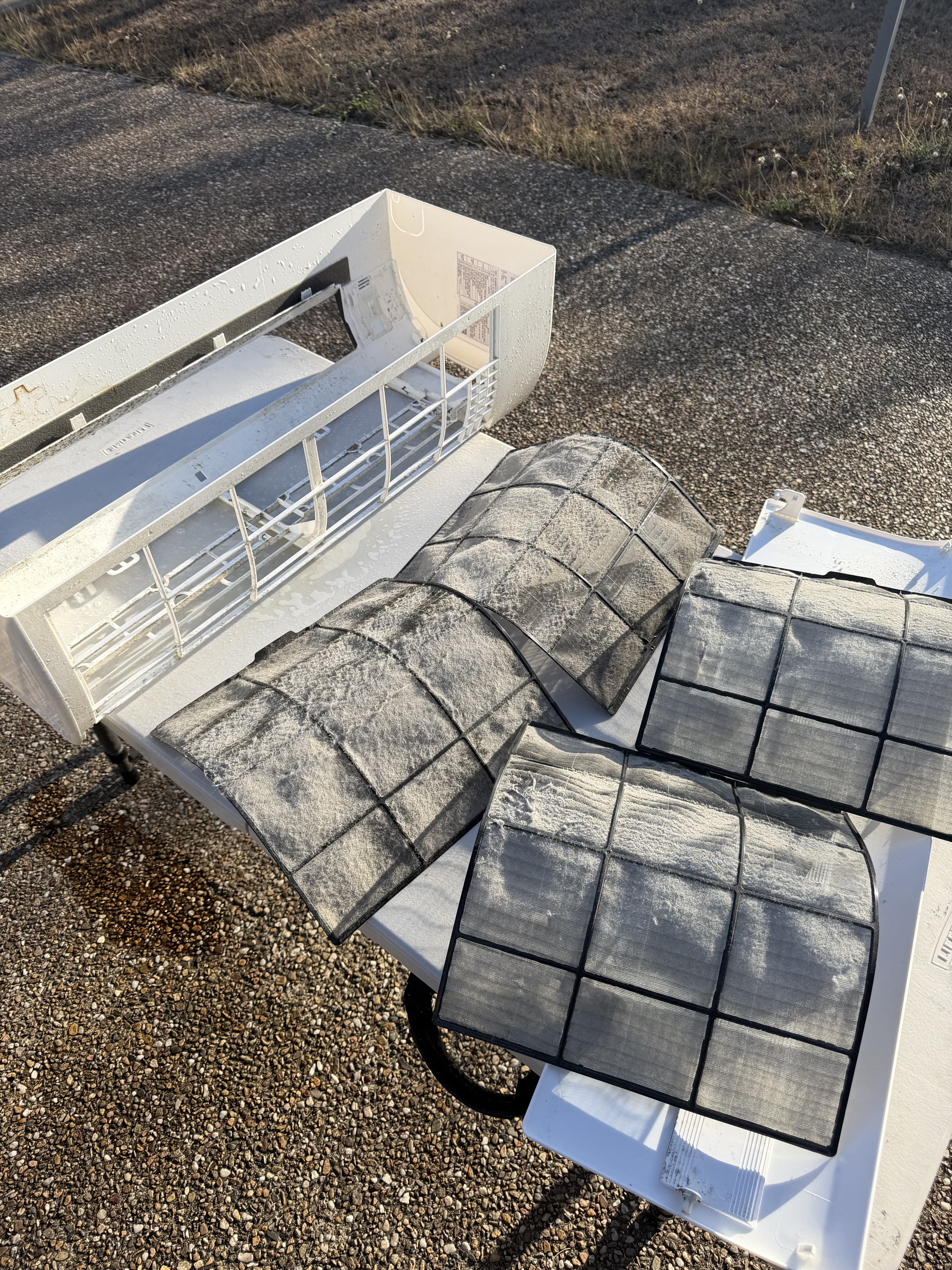 Heavily soiled air conditioner filters removed for washing during a deep clean
