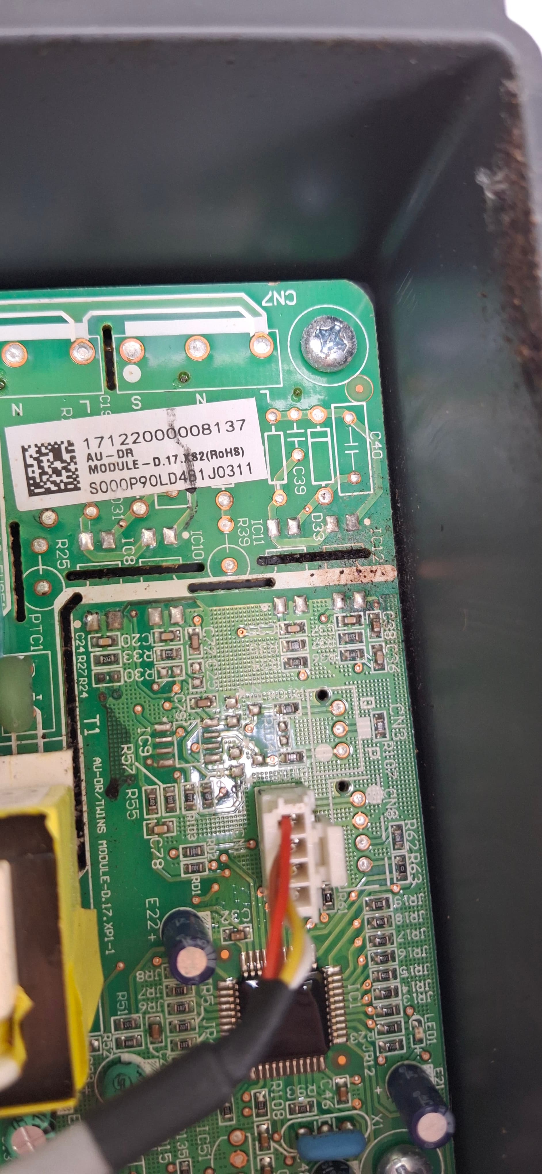 Close-up inspection of a control circuit board while fault finding a split system