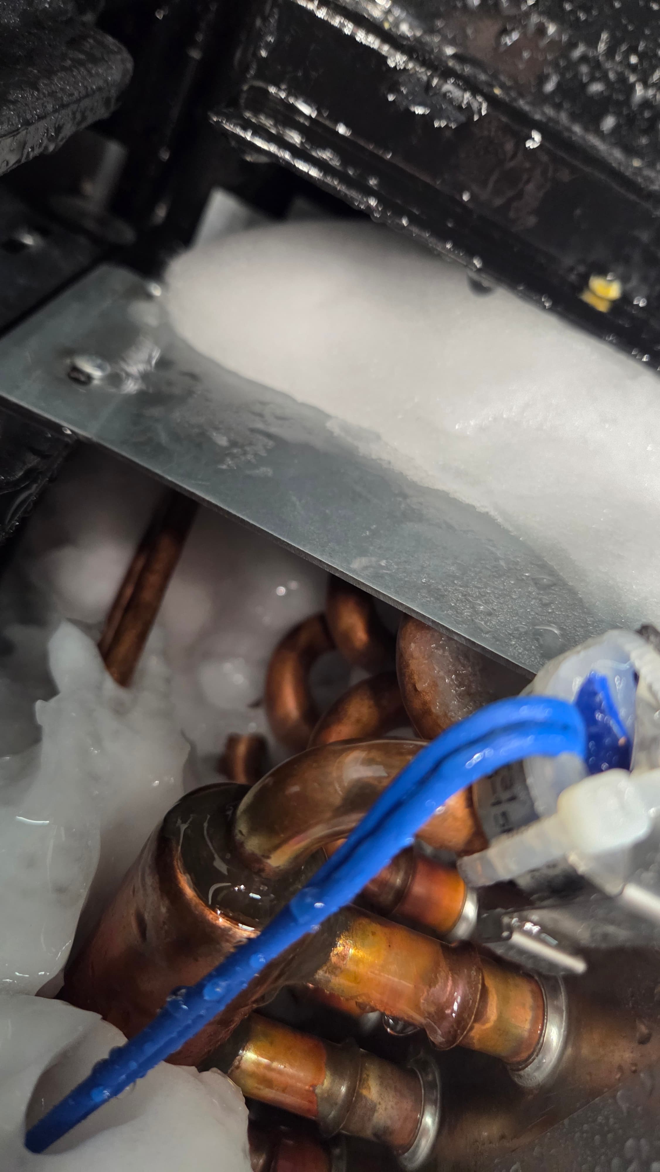 Ice built up on an evaporator coil and copper pipework found during a fault-finding job